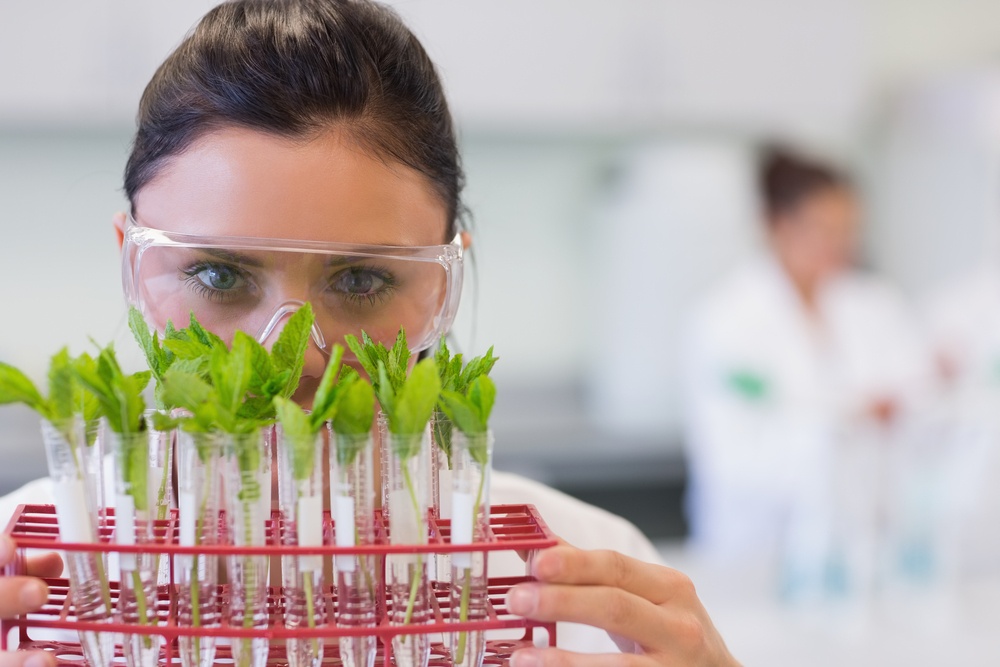 Close-up portrait of a female scientist with young plants at the laboratory-1