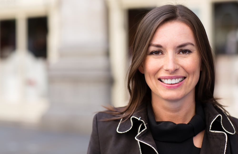 Business woman looking very happy outdoors and smiling