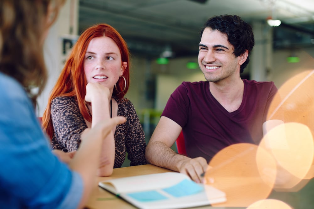 Unposed group of creative business people in an open concept office brainstorming their next project.-4